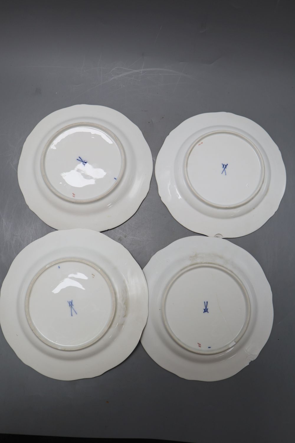 A set of four Meissen dishes, painted with scattered floral sprigs